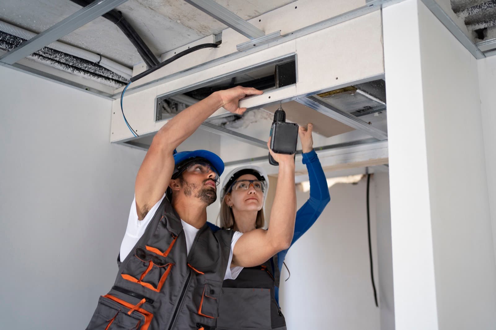 HVAC services procurement savings: technicians installing commercial ductwork for multi-brand HVAC platforms